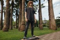 Boy riding longboard on boardwalk, warm summer time Royalty Free Stock Photo