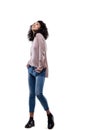 Young curly woman in jeans, pink sweater, posing