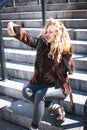 Young curly woman using her phone and relax in the city Royalty Free Stock Photo