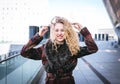 Young curly woman using her phone and relax in the city Royalty Free Stock Photo