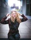 Young curly woman using her phone and relax in the city Royalty Free Stock Photo