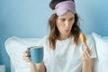 Young curvy woman taking a breakfast on the bed with cup of coffee and croissant Royalty Free Stock Photo