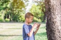 Young cute asian boy using a smartphone to play game Royalty Free Stock Photo
