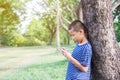 Young cute asian boy using a smartphone to play game Royalty Free Stock Photo