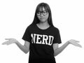 Young cute Asian nerd teenage girl shrugging shoulders Royalty Free Stock Photo