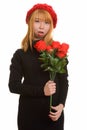 Young cute Asian woman holding red roses looking shocked Royalty Free Stock Photo