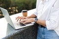 Young cute beautiful woman walking outdoors using laptop computer Royalty Free Stock Photo