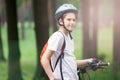 Young cute boy in helmet rides a bicycle in the park. Boy goes on the road. Sport, Royalty Free Stock Photo