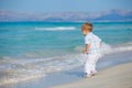 Young cute boy playing happily at pretty beach Royalty Free Stock Photo