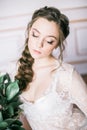 Young cute bride with beautiful hair in the morning at home in white negligee Royalty Free Stock Photo