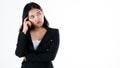 Young and cute businesswoman in black suit poses in thinking gesture and looking to blank space Royalty Free Stock Photo