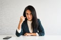 Young cute caucasian brunette business woman director in office show fist to camera at work for employee resentful angry serious