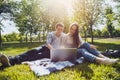 Young cute couple using a laptop in the Park on a Sunny day Royalty Free Stock Photo