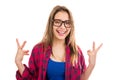 Young cute excited woman in glasses holding cool gesture sign celebrating victory