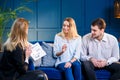 Young cute family on the meeting with realtor, interior designer, decorator. Royalty Free Stock Photo