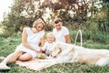 Young cute family on picnic with dog Royalty Free Stock Photo