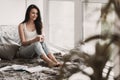 Young Cute Female Student Drinking Coffee in Bed Royalty Free Stock Photo