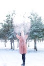 Young cute girl with durk hair has fun in snowy weather in winter in the park. Royalty Free Stock Photo