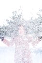Young cute girl with durk hair has fun in snowy weather in winter in the park. Royalty Free Stock Photo