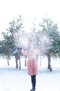 Young cute girl with durk hair has fun in snowy weather in winter in the park. Royalty Free Stock Photo