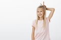 Young cute girl fooling around while playing in park with friends. Portrait of happy adorable child in pink t-shirt Royalty Free Stock Photo