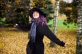 Young cute girl in a hat, beautiful autumn day in the park. Festive season in October. Halloween witch hat Royalty Free Stock Photo