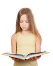 Young cute girl with long light brown hair reading the yellow book Royalty Free Stock Photo