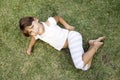 Young cute girl lying on the grass