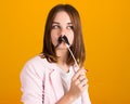 Young cute girl with moustache, studio Royalty Free Stock Photo