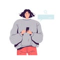 A young cute girl in a sweater holds a phone in her hands and uses the search engine in her mobile device