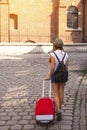 Young cute girl travels through the cities of old Europe.