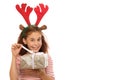 Adorable young girl with a Christmas present Royalty Free Stock Photo