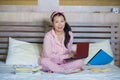 Young cute and happy nerdy Asian Korean student teenager girl in nerd glasses and hair ribbon studying at home bedroom sitting on Royalty Free Stock Photo