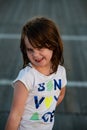 Young cute little girl on the boardwalk looking at camera smiling Royalty Free Stock Photo