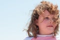 Young cute little girl playing at the seaside running into the surf on a sandy beach in summer sunshine Royalty Free Stock Photo