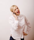 Young cute real girl talking on phone against white background, lifestyle people concept Royalty Free Stock Photo