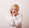 Young cute real girl talking on phone against white background, lifestyle people concept Royalty Free Stock Photo