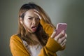 Young cute and sad Asian Korean girl feeling broken heart and desperate holding mobile phone suffering relationship break up Royalty Free Stock Photo