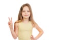Young cute smiling  girl with long light brown hair shows victory sign Royalty Free Stock Photo