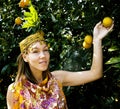 Young cute smiling woman in park with oranges, lifestyle concept Royalty Free Stock Photo