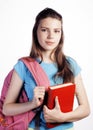 Young cute teenage girl posing cheerful against white background with books and backpack Royalty Free Stock Photo