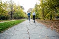 Cute teenager girl and boy riding electric kick scooter in the park. Royalty Free Stock Photo