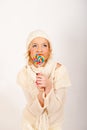 Young cute winter girl with lollipop candy