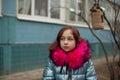 Young woman in blue vegan and faux fur coat is posing on urban city background. Fashion trendy style clothes Royalty Free Stock Photo