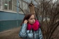 Young woman in blue vegan and faux fur coat is posing on urban city background. Fashion trendy style clothes Royalty Free Stock Photo