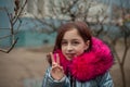 Young woman in blue vegan and faux fur coat is posing on urban city background. Fashion trendy style clothes Royalty Free Stock Photo