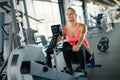 Young cute woman doing exercises with rowing machine Royalty Free Stock Photo