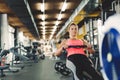 Young cute woman doing exercises with rowing machine Royalty Free Stock Photo