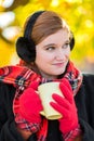 Young cute woman / girl drinking hot chocolate / cocoa/ tea in t Royalty Free Stock Photo