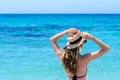 Young cute woman over turquoise sea at tropical beach during vacation